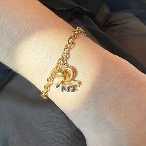 Nina Ricci Gold Bracelet with NR Charm